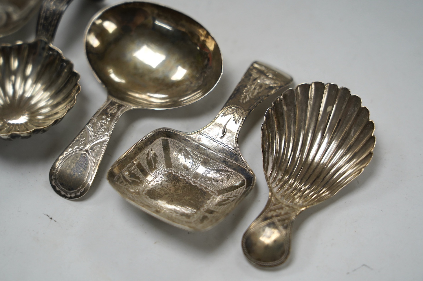 Five assorted silver caddy spoons, including shovel shape by Cocks & Bettridge, Birmingham, 1808, 71mm, oval bowl, John Blake, London, 1804, square bow, Joseph Wilmore, Birmingham, 1810, shell bowl, Joseph Taylor, Birmin